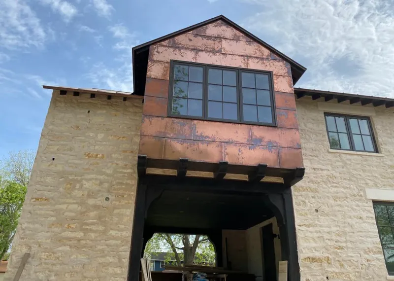 Copper metal panel facade on a stone building for Metal Roof Coating in Carmel