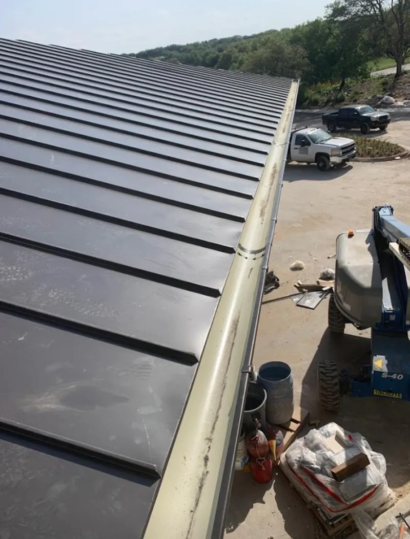 Standing seam panel and gutter detail on a metal roofing jobsite in Carmel